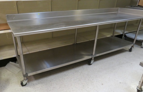 pre owned stainless prep table on casters with under shelf 108" x 30" W X 32" h with 4" back splash
