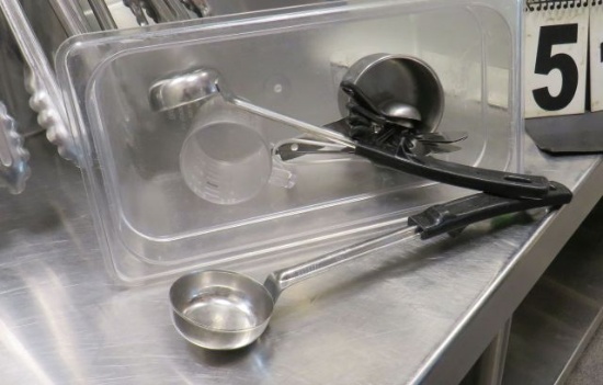 mixed kitchen utensils measuring cups, peelers, scoops