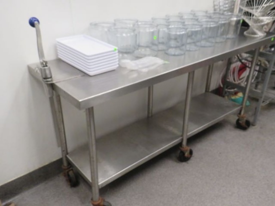stainless steel table on casters with undershelf and can opener 72" long x 24" deep x