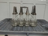 8 glass oil bottles w/ spouts & wire case