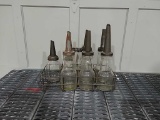 7 glass oil bottles w/ spouts & wire rack