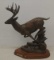Deer bronze statue hightailing it
