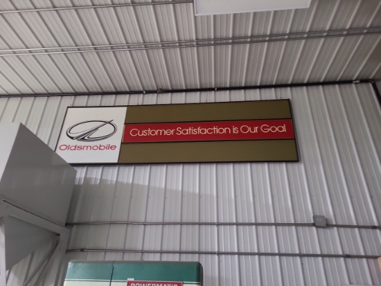 Oldsmodile Customer satisfaction is our goal sign.
