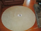 72 IN ROUND WOVEN RUG-LIKE NEW