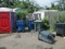 LOT-APPROX 30 TRASH ROLLING TOTES-PLUS SPARE LIDS/AXLES TIRES & 2 OIL DRAIN PANS ON OUTSIDE LOT