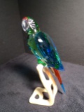 Swarovski crystal Macaw on a wood base.