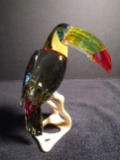 Swarovski crystal Toucan on a wood base.