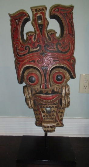 Wood carved Mask, painted with red and black details.