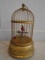 Bird in a metal bird cage, winds up to sing realistic bird sounds