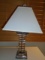 Lucite table lamp with off white lamp shade.