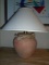 Table lamp with off white lamp shade & seashell decorations.