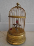 Bird in a metal bird cage, winds up to sing realistic bird sounds
