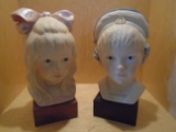 Pair of boy & girl porcelain busts on a wood block base
