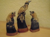 3 pc carved tusks on wooden bases, 2 wolves and a bird.
