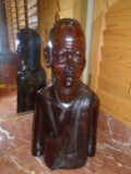 Wood carved statue of a male African man.