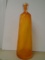 Orange glass bottle with swirl design.