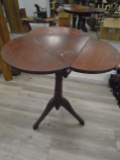 Small vintage wooden side table with 3 drop leaf sides.