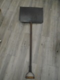 Antique shovel with wooden handle and metal head.