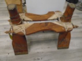 Antique wood stool with leather and riveted studs.
