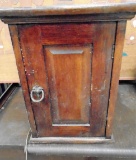 Antique speakers in a wooden box with a door.
