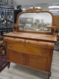 Antique wooden dresser with mirror.