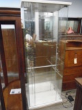 Glass display cabinet with white lacquered top and base.