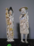 Pair of Hand carved bone oriental figurines on a wood base.