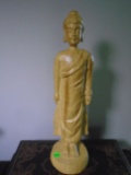 Wood carved standing thai buddha.