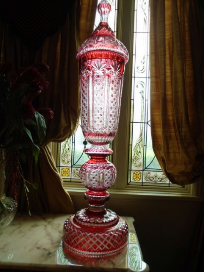 Pair of Palatial lidded crystal urns. Cranberry red with crystal cut design.