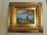 Oil Painting of a landscape in a gold frame.