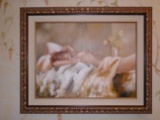Oil painting in a gold frame. Depicts a nude woman laying down.