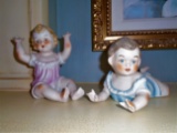 Pair of Male & Female Porcelain Piano babies.
