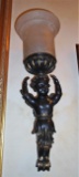 Pair of bronze wall sconces, features a boy angel, and glass shade.