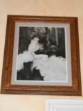 Etching in a frame. Depicts a woman with a white dress.  Hand signed by the artist Louis Icart.
