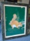 Framed wall art, depicts a squirrel with green background.