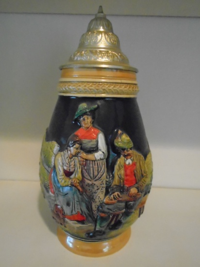 Beer stein with scene featuring 3 figures and a dog.