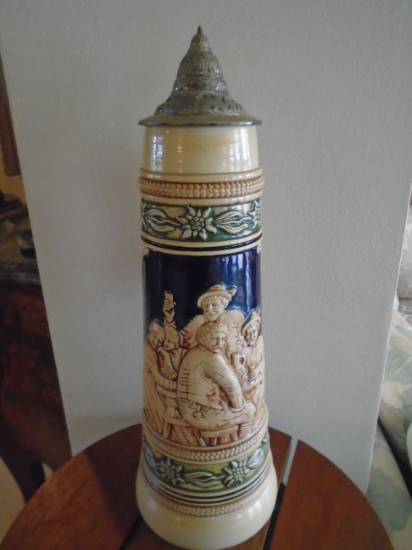 Large beer stein with scene of 5 figures at a bar.