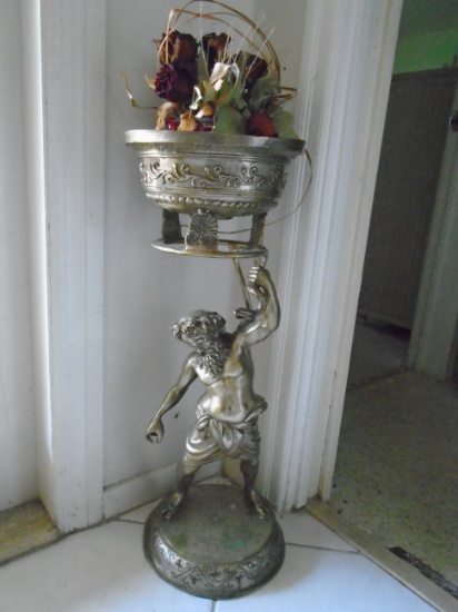 Metal pedestal/plant holder depicting a man holding a snake.