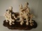 Carved and etched hippo ivory Sculpture of a man sitting on a bench with 4 playful children.