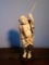 Carved and etched hippo ivory Sculpture of a Male figure holding a pipe in one hand and a stick in h