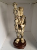 Carved and etched hippo ivory Sculpture of man holding puppet.