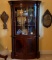 Henredon Oval Front China Cabinet With Nine Glass Panels For Viewing. Scrolled Columns Up The Front