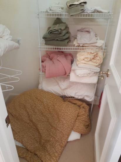 Closet of contents - towels, bedspread - no racks