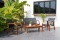 BRAND NEW OUTDOOR 4-PERSON SOLID 100% FSC WOOD SEATING SET WITH BLACK SLING - ORIGINAL PACKAGING