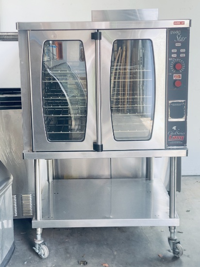 Lang Enviro Star single deck gas convection oven on stainless steel equipment stand on casters. The
