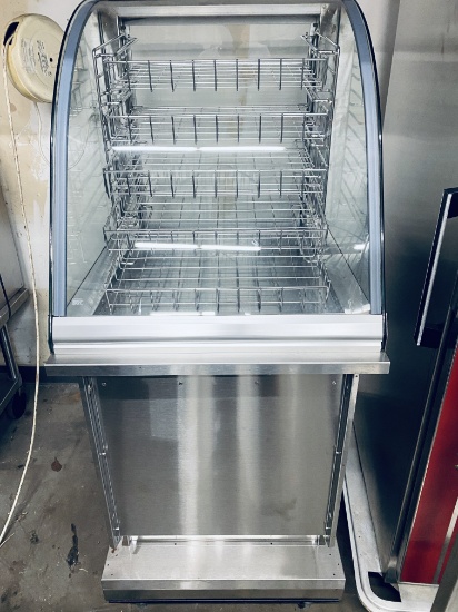 European curved glass dry bakery case with underneath storage for six full-size sheet pans. This uni
