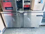 Continental 60 in two door under counter stainless steel refrigerated work table mounted on casters