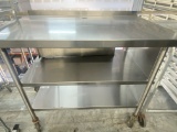 48 inch all stainless steel work table with two stainless steel shelves 2 inch backsplash mounted on