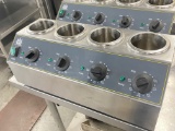 Carnival King heated condiment rail holds four condiment bottles each one with its own individual te