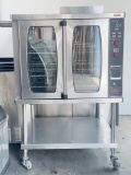 Lang Enviro Star single deck gas convection oven on stainless steel equipment stand on casters. The